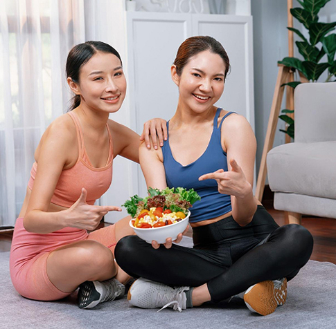 Happy Asian sportswomen promoting wellness and vitality at Synergy Women’s Health