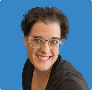 Anne, Synergy Women's Health Care medical assistant and clinic supervisor, smiling and wearing glasses